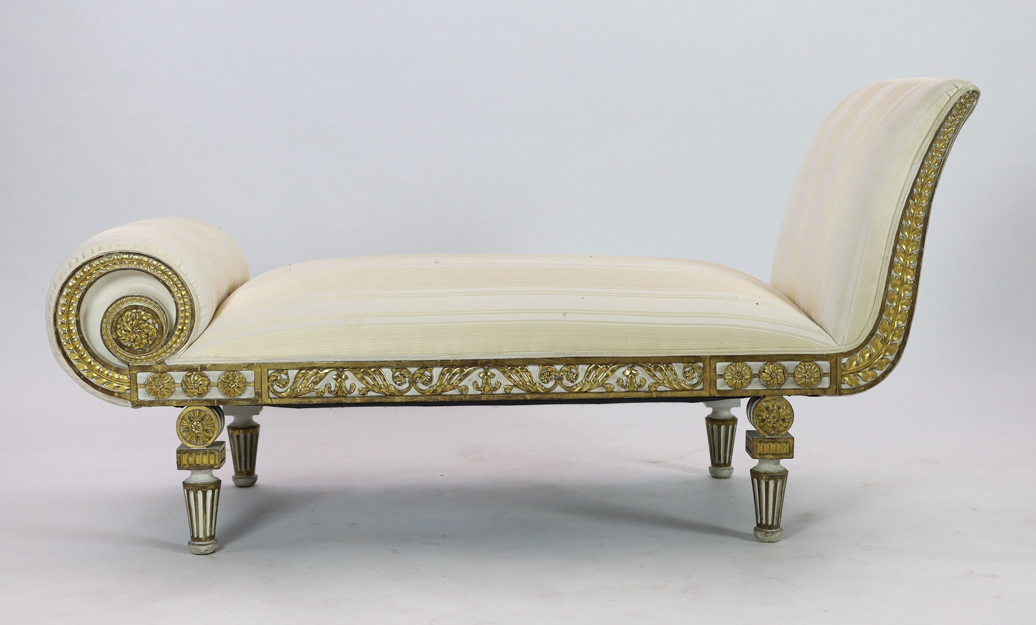 A Regency white painted and parcel gilt chaise longue, L.166cm W.63cm H.84cm